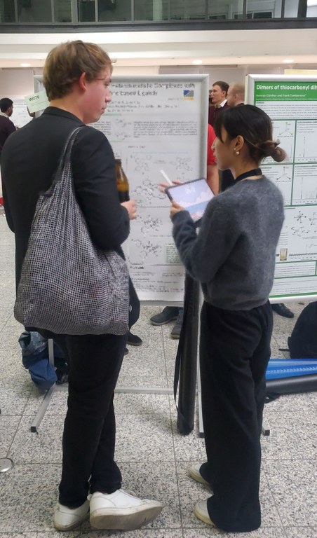 Jiaxin discussing in front of her poster. Jiaxin discussing in front of her poster.